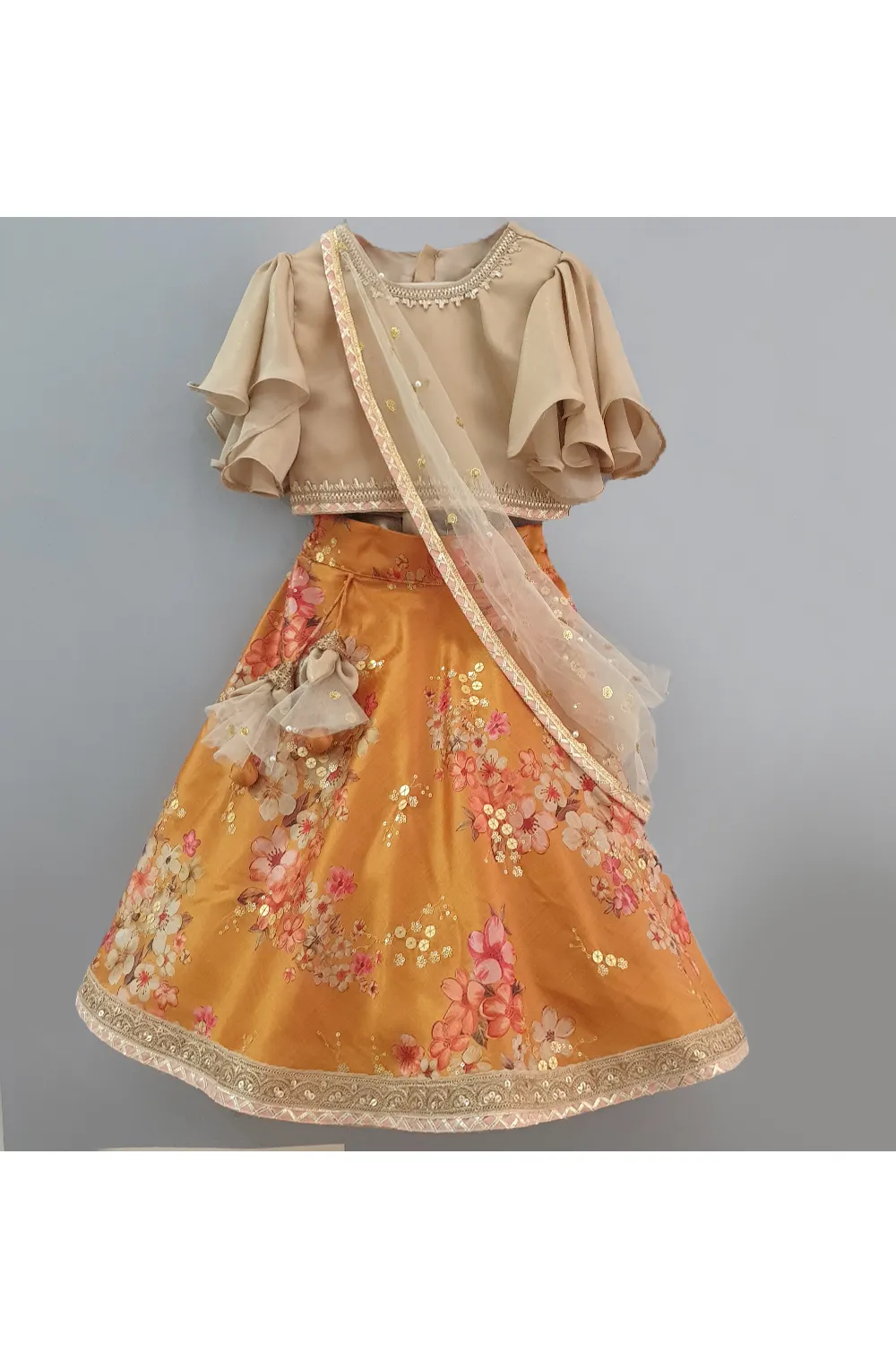 Golden beige top with attached dupatta and mustard floral lehenga