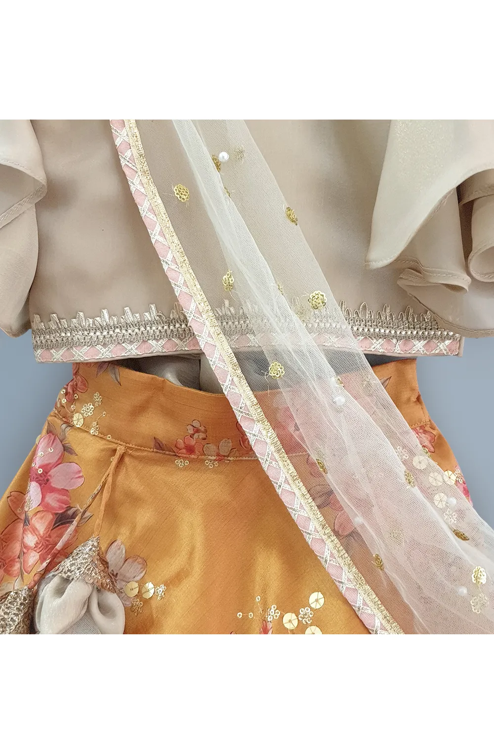 Golden beige top with attached dupatta and mustard floral lehenga